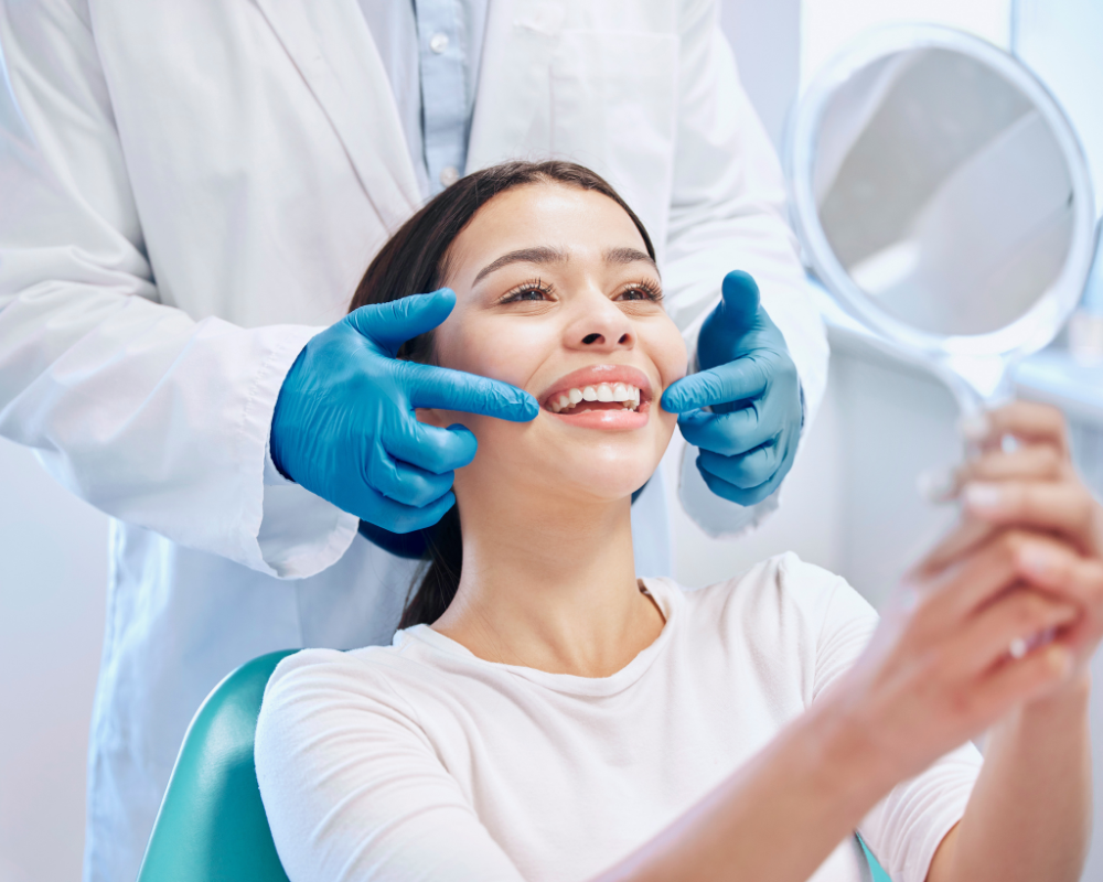 Female patient smiling while looking at mirror